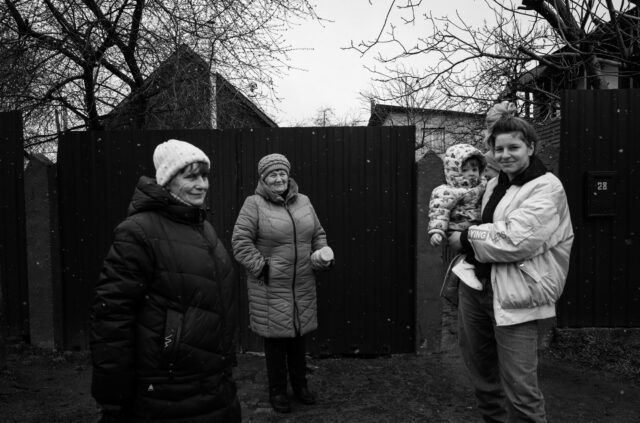 Women talking in the street the day after the liberation, they have been hiding inside for weeks.