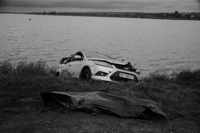 Landscape with the remains of military and civillian vehicles.