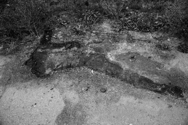 The silhouette of a civilian casualty that litterally melted on the asphalt road.