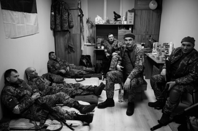At a secret military base, Ukrainian forces prepare for the Russian invasion, a group of armed men in camouflage looking at camera lying down sitting, Kyiv, Ukraine - 07/03/2022.