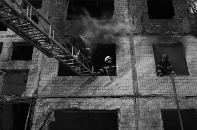 Firemen in a burning building after an airstrike, Kyiv, Ukraine - 14/03/2022