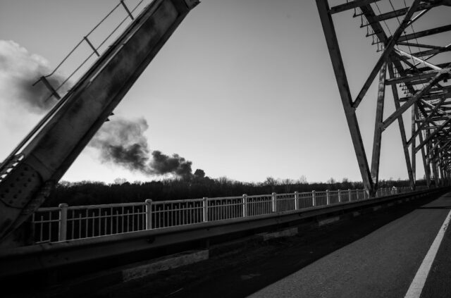Last bridge and route to enter Chernihiv, smoke from the conflict on the horizon.