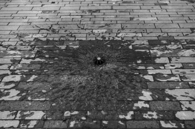 A street with a mortar that dug its way in the cobble stones.