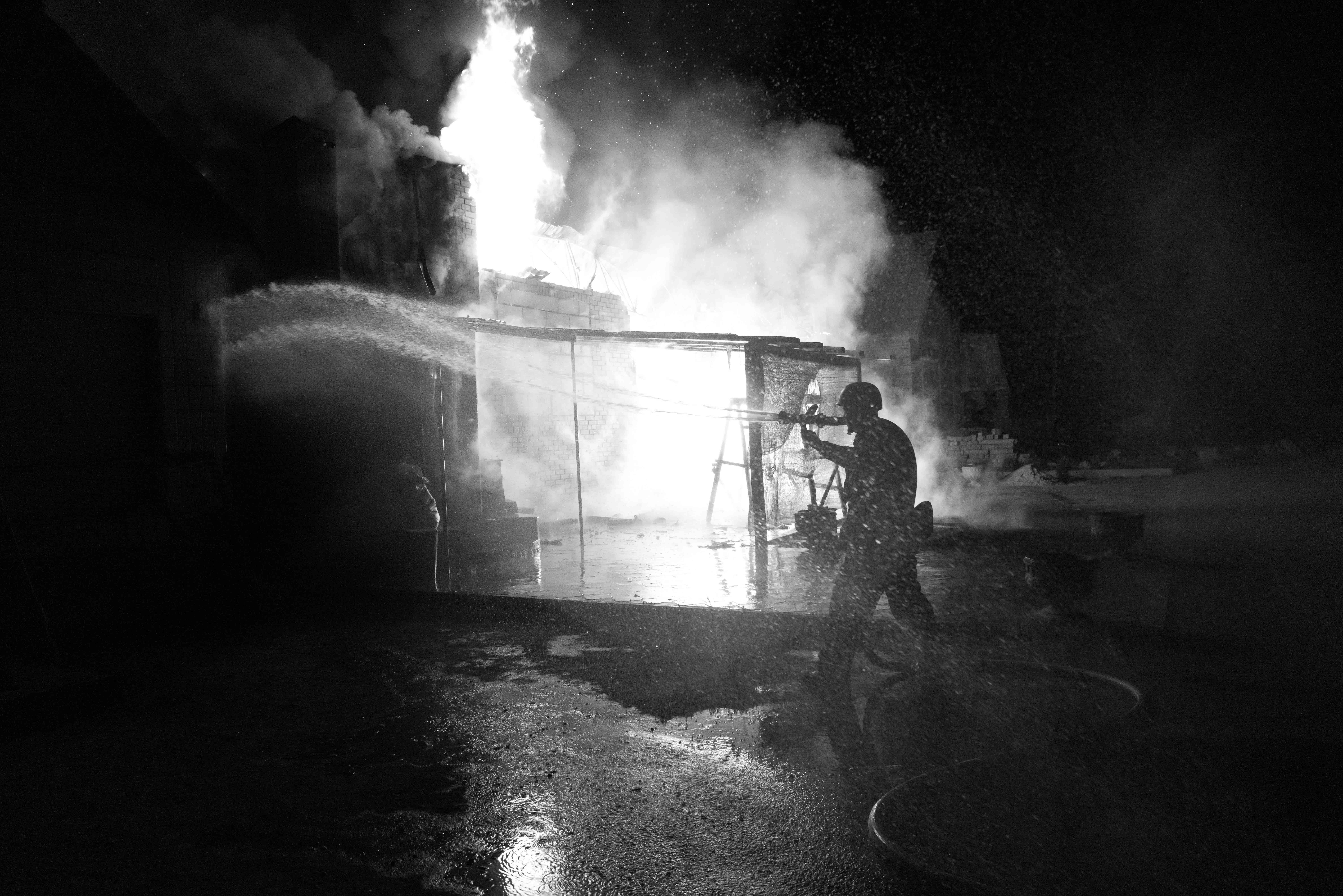 Borova, Ukraine - An electrical fire erupts in a home the day after a missile strike near a restaurant bar in a street